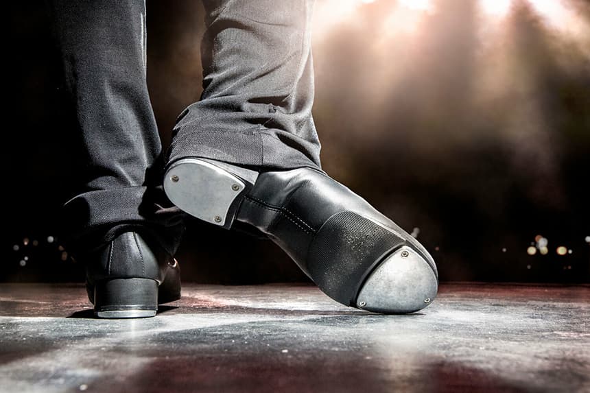 Tap dancing on stage, seeing the metal plates on the dancers shoes as he begins to tap