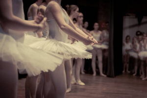 Dancing class of ballet dancers on stage