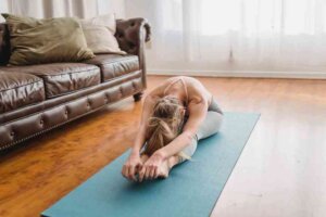 Forward bend stretch - image of young lady doing this in front room, head touching her knees